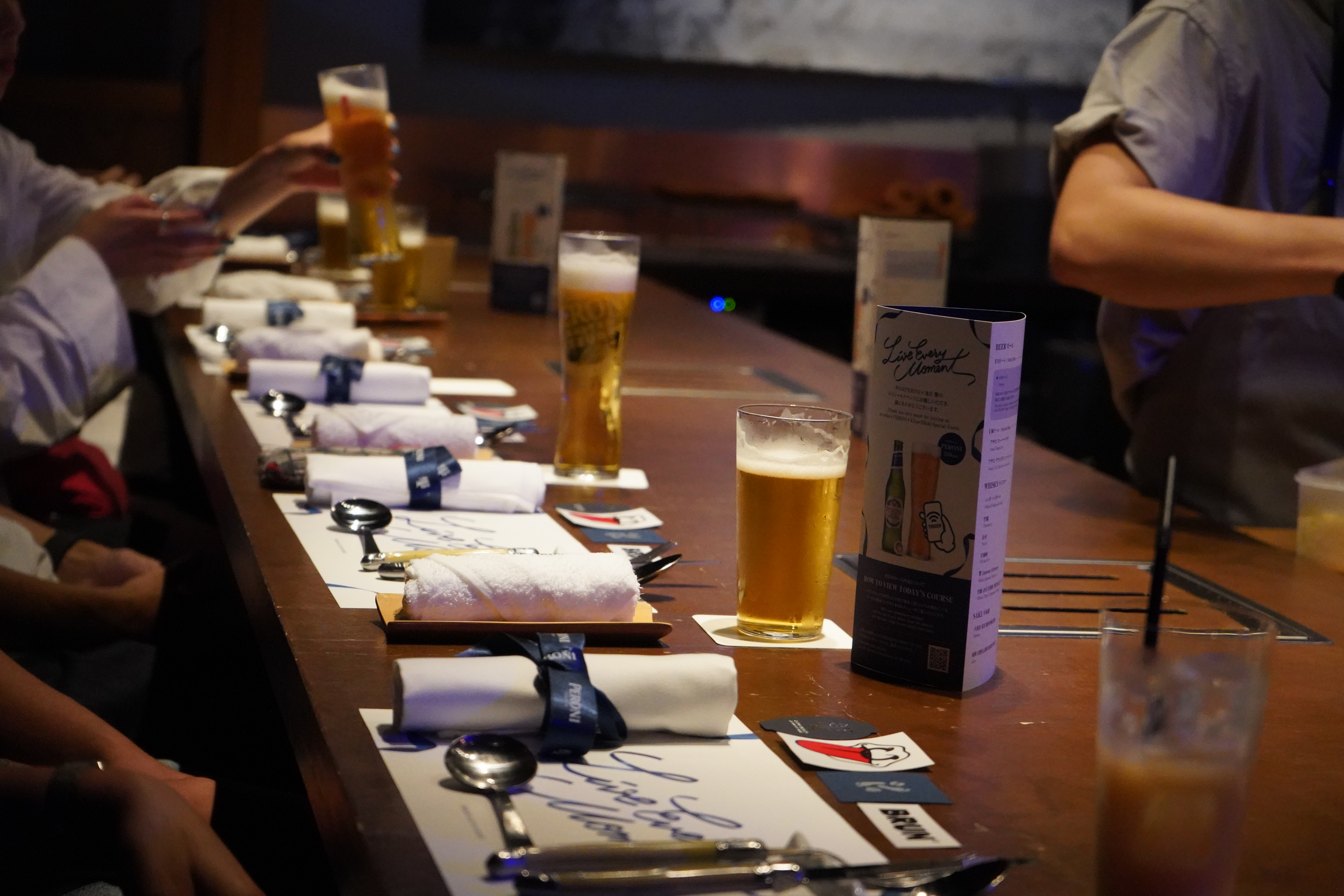 The Peroni table setting with branded napkins, the course menu and a glass of lager