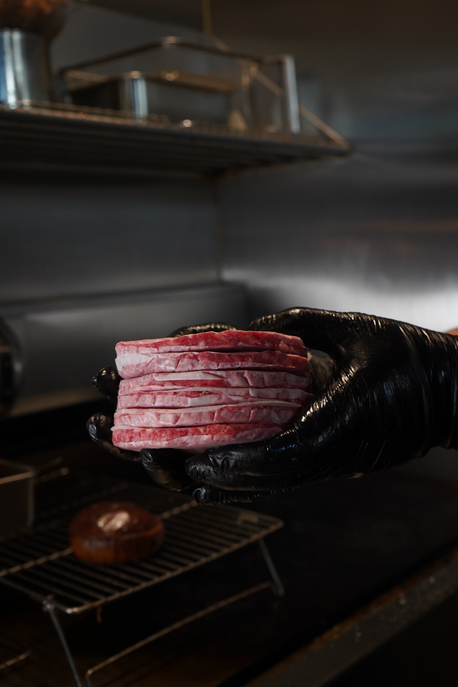 Hand-formed wagyu patties by the grill